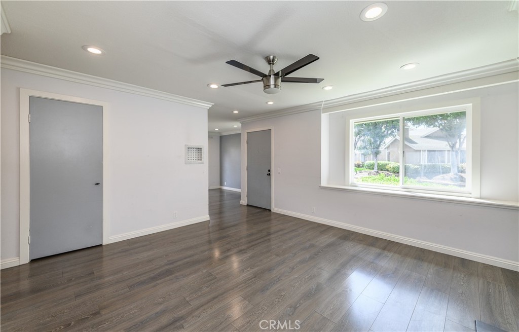2 Hollowglen, Unit 7 Irvine, CA 92604 - Photo 7 of 31 a view of an empty room with wooden floor and a window