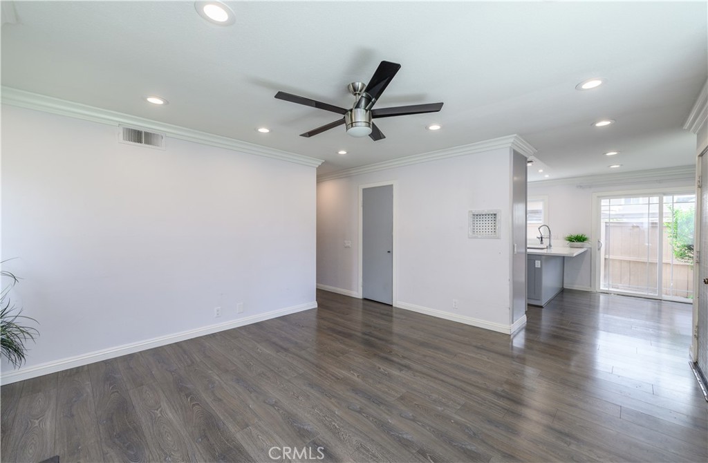 2 Hollowglen, Unit 7 Irvine, CA 92604 - Photo 8 of 31 a view of an empty room with a window and wooden floor