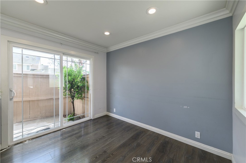 2 Hollowglen, Unit 7 Irvine, CA 92604 - Photo 9 of 31 an empty room with wooden floor and windows