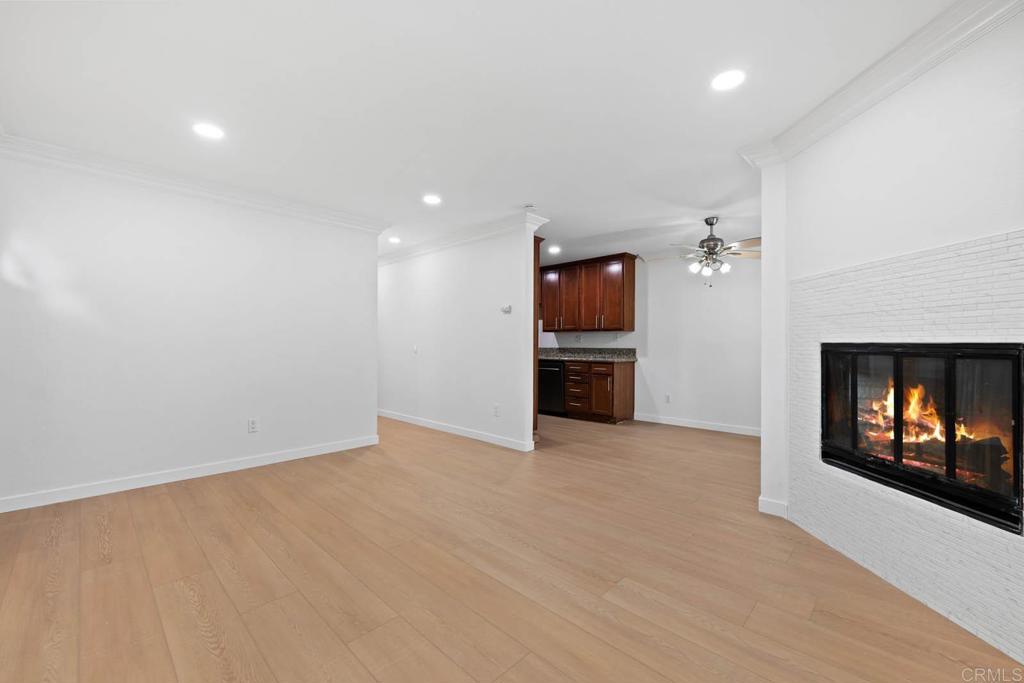 855 East Lexington Avenue, Unit 4 El Cajon, CA 92020 - Photo 2 of 12 an empty room with kitchen and fireplace