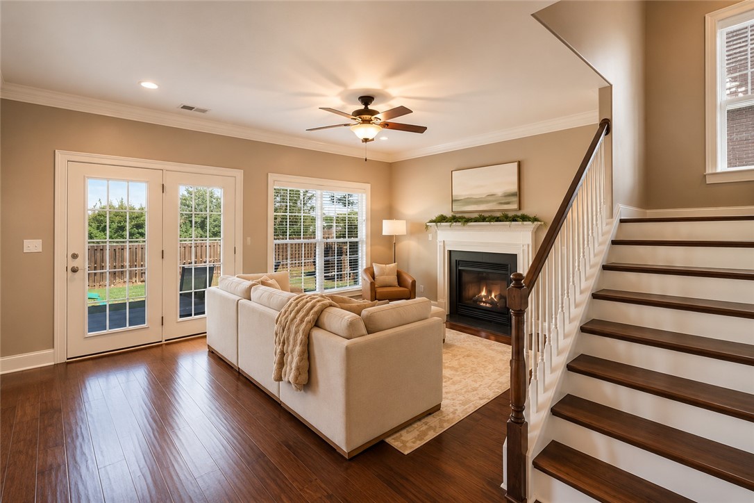 15 Fawn Hill Drive Anderson, SC 29621 - Photo 6 of 38 This inviting space features elegant hardwood flooring and a cozy fireplace, perfect for gatherings.