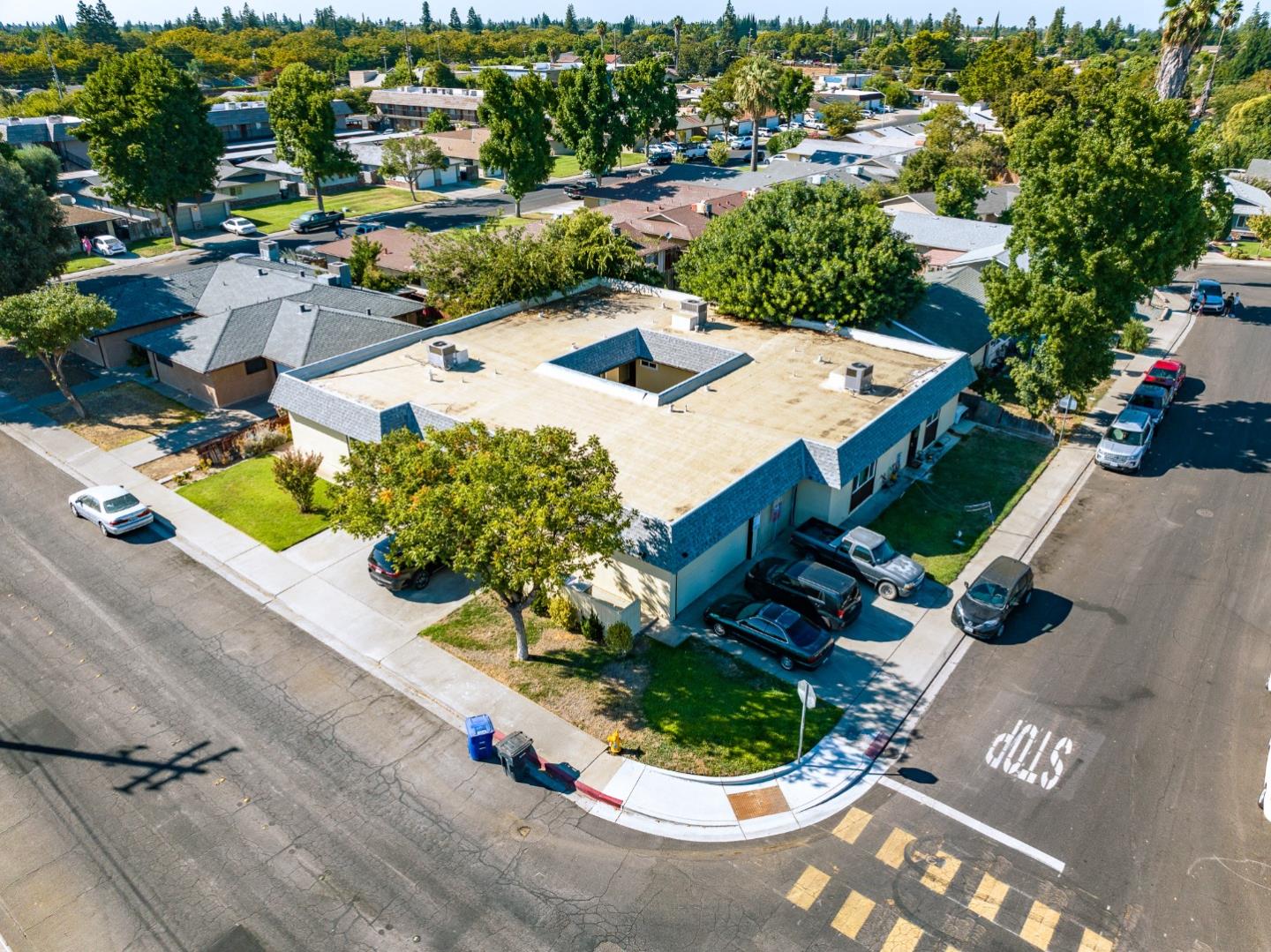 an aerial view of a house with garden space and street view