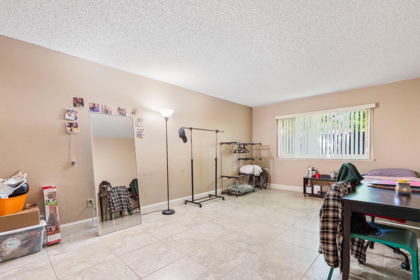 1317 East Rumble Road Modesto, CA 95355 - Photo 12 of 21 a living room with furniture a window and gym equipment