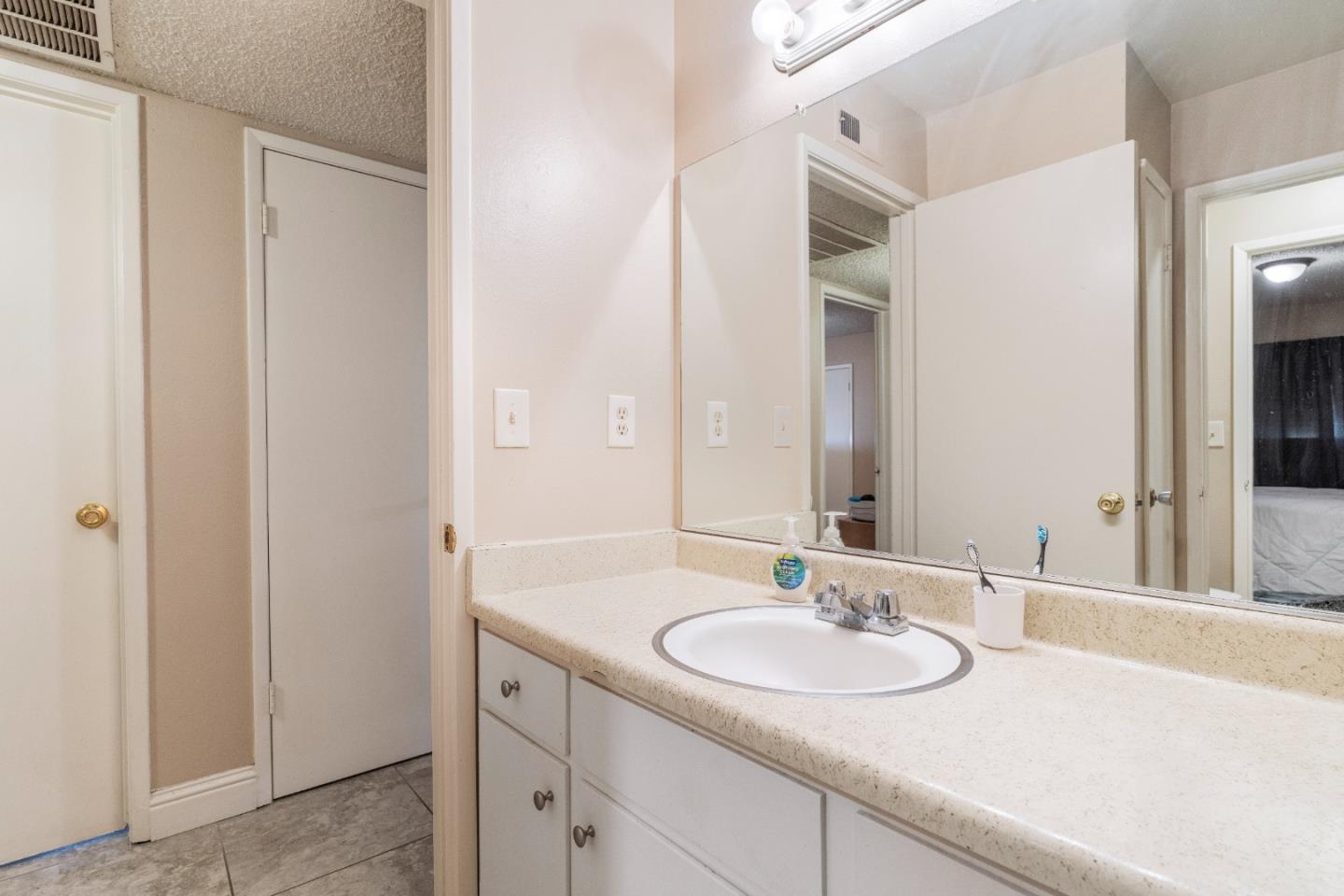 1317 East Rumble Road Modesto, CA 95355 - Photo 18 of 21 a bathroom with a sink and a mirror