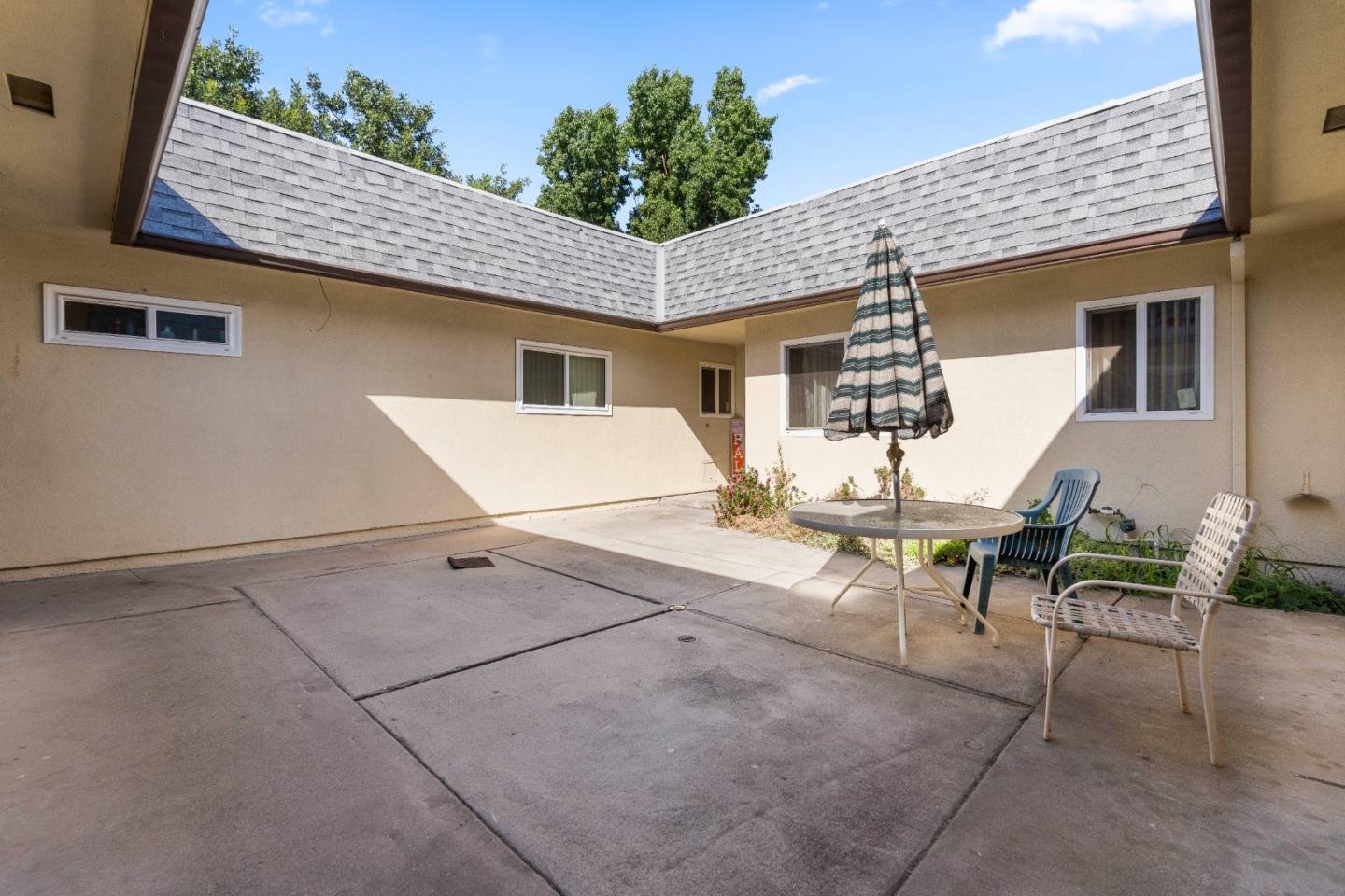 1317 East Rumble Road Modesto, CA 95355 - Photo 6 of 21 a view of a patio with table and chairs and potted plants