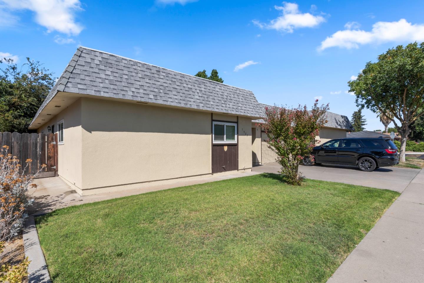1317 East Rumble Road Modesto, CA 95355 - Photo 7 of 21 a front view of a house with a garden