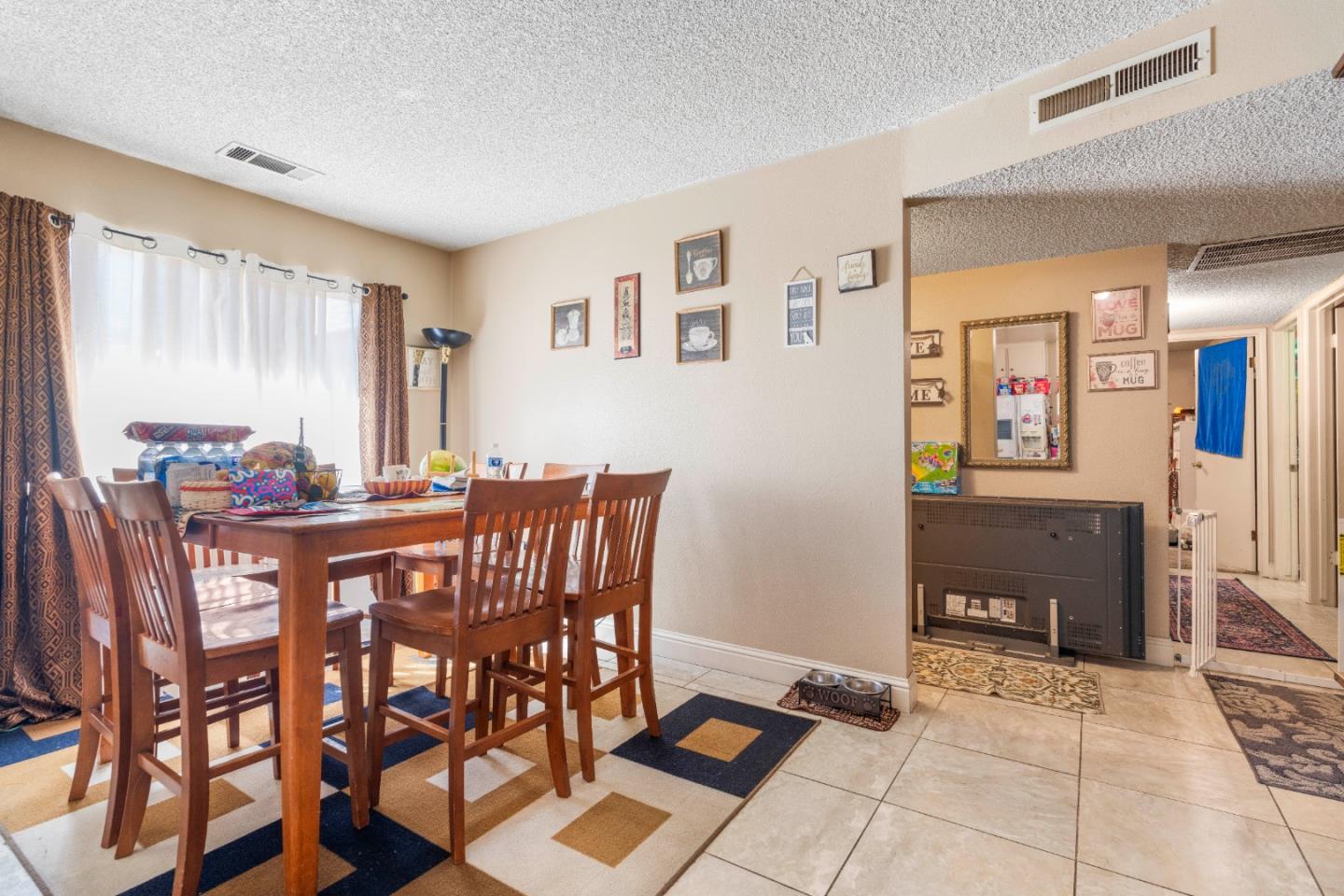 1317 East Rumble Road Modesto, CA 95355 - Photo 8 of 21 a view of a dining room with furniture and a window