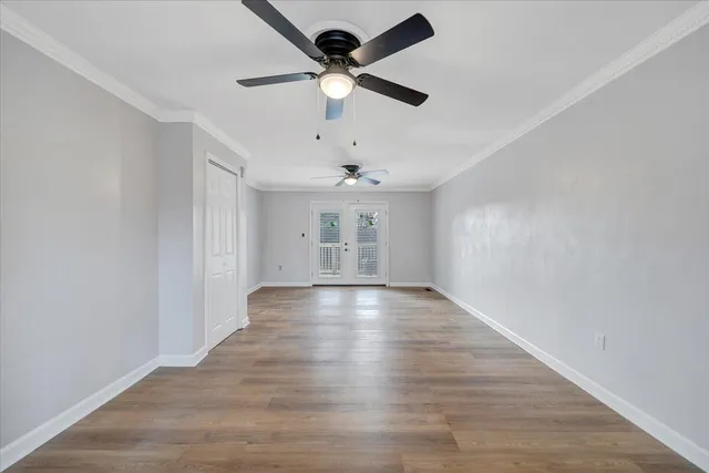 wooden floor in an empty room with a window