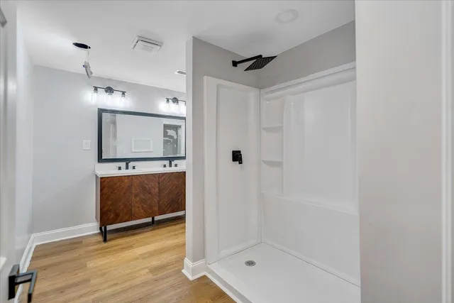 a bathroom with a mirror and a shower