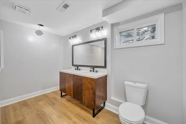 a view of bathroom with a toilet sink and mirror