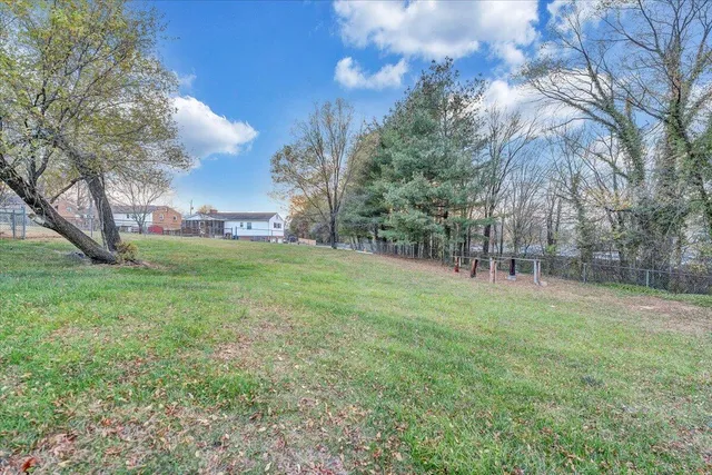 a view of a field with trees around