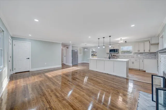 a large kitchen with kitchen island a sink stainless steel appliances and cabinets