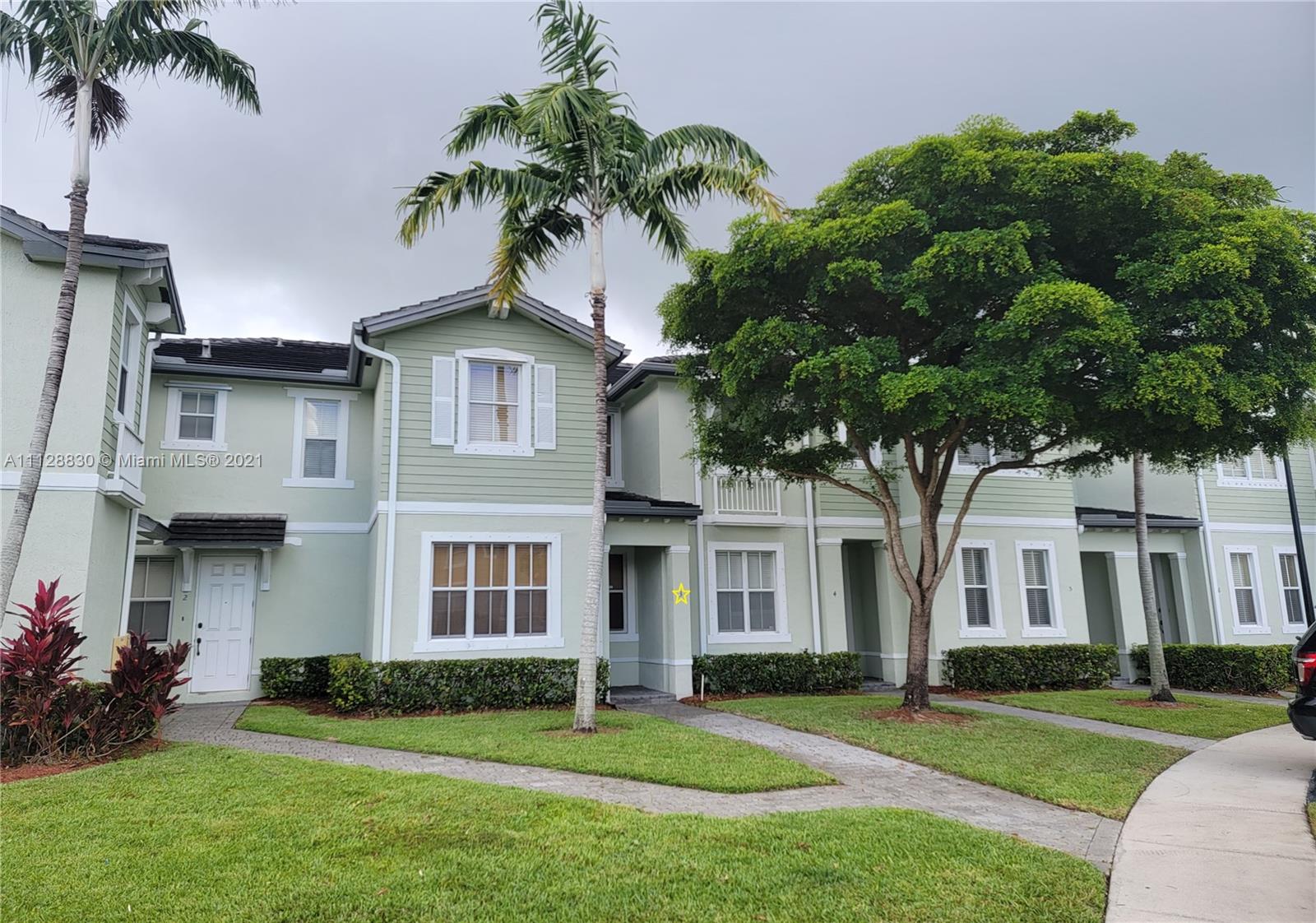 152 Southeast 29th Avenue, Unit 3 Homestead, FL 33033 - Photo 2 of 28 a front view of a house with a garden