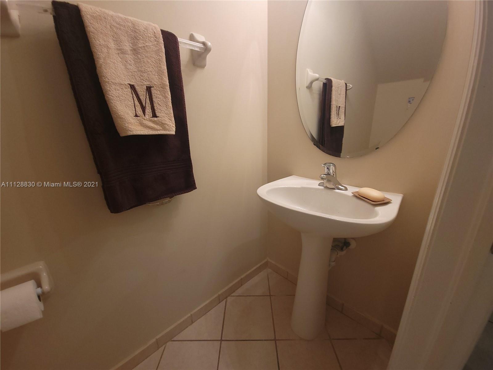 152 Southeast 29th Avenue, Unit 3 Homestead, FL 33033 - Photo 11 of 28 a bathroom with a sink and mirror