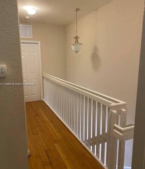 152 Southeast 29th Avenue, Unit 3 Homestead, FL 33033 - Photo 13 of 28 a view of a hallway with wooden floor