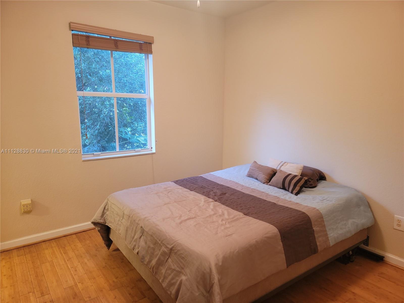152 Southeast 29th Avenue, Unit 3 Homestead, FL 33033 - Photo 15 of 28 a bedroom with a bed and a window