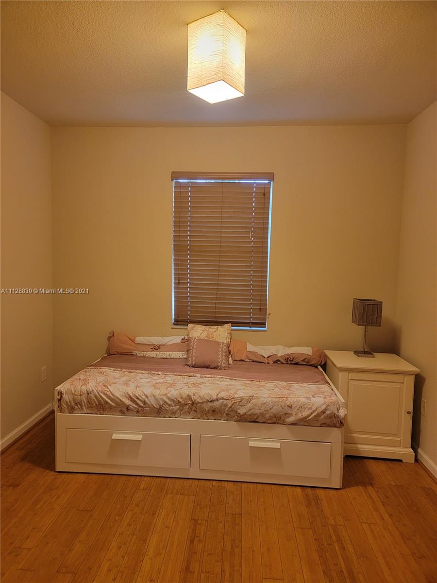 152 Southeast 29th Avenue, Unit 3 Homestead, FL 33033 - Photo 17 of 28 a bedroom with a bed and a window