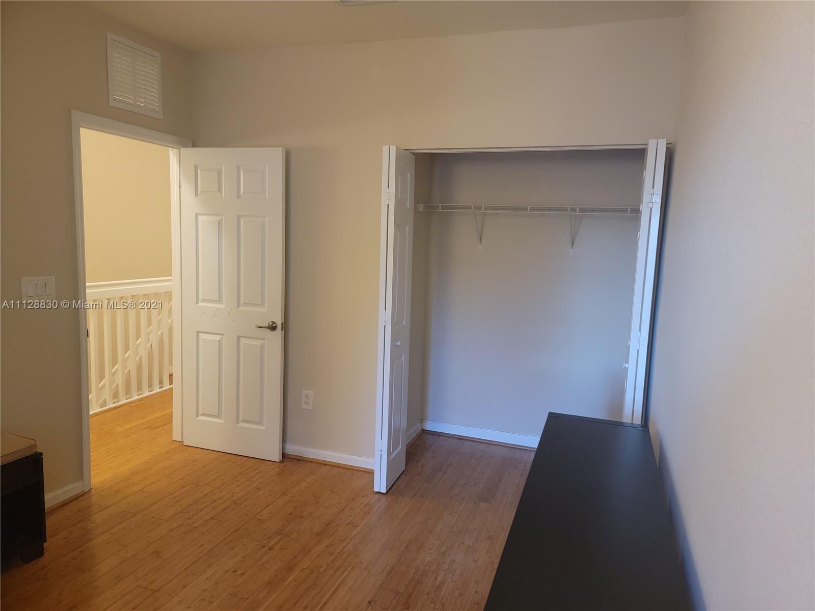 152 Southeast 29th Avenue, Unit 3 Homestead, FL 33033 - Photo 18 of 28 a view of a room with wooden floor and closet area