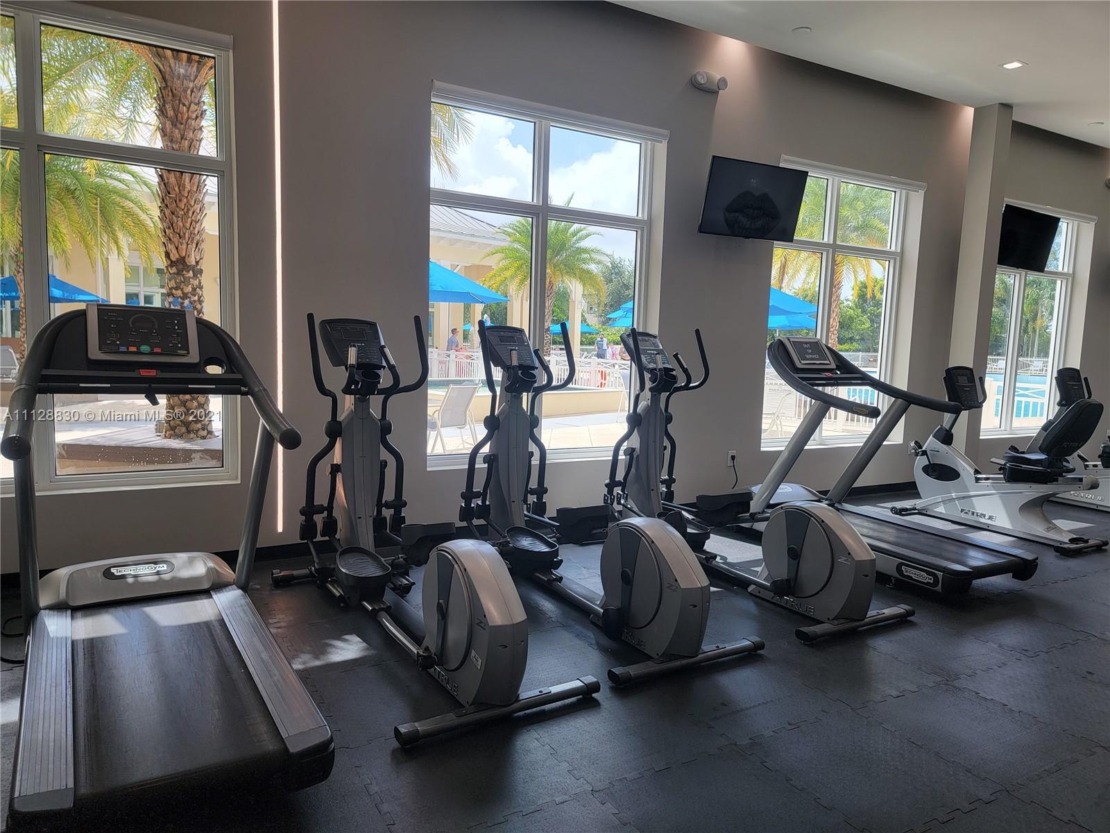 152 Southeast 29th Avenue, Unit 3 Homestead, FL 33033 - Photo 20 of 28 a room with gym equipment and large windows