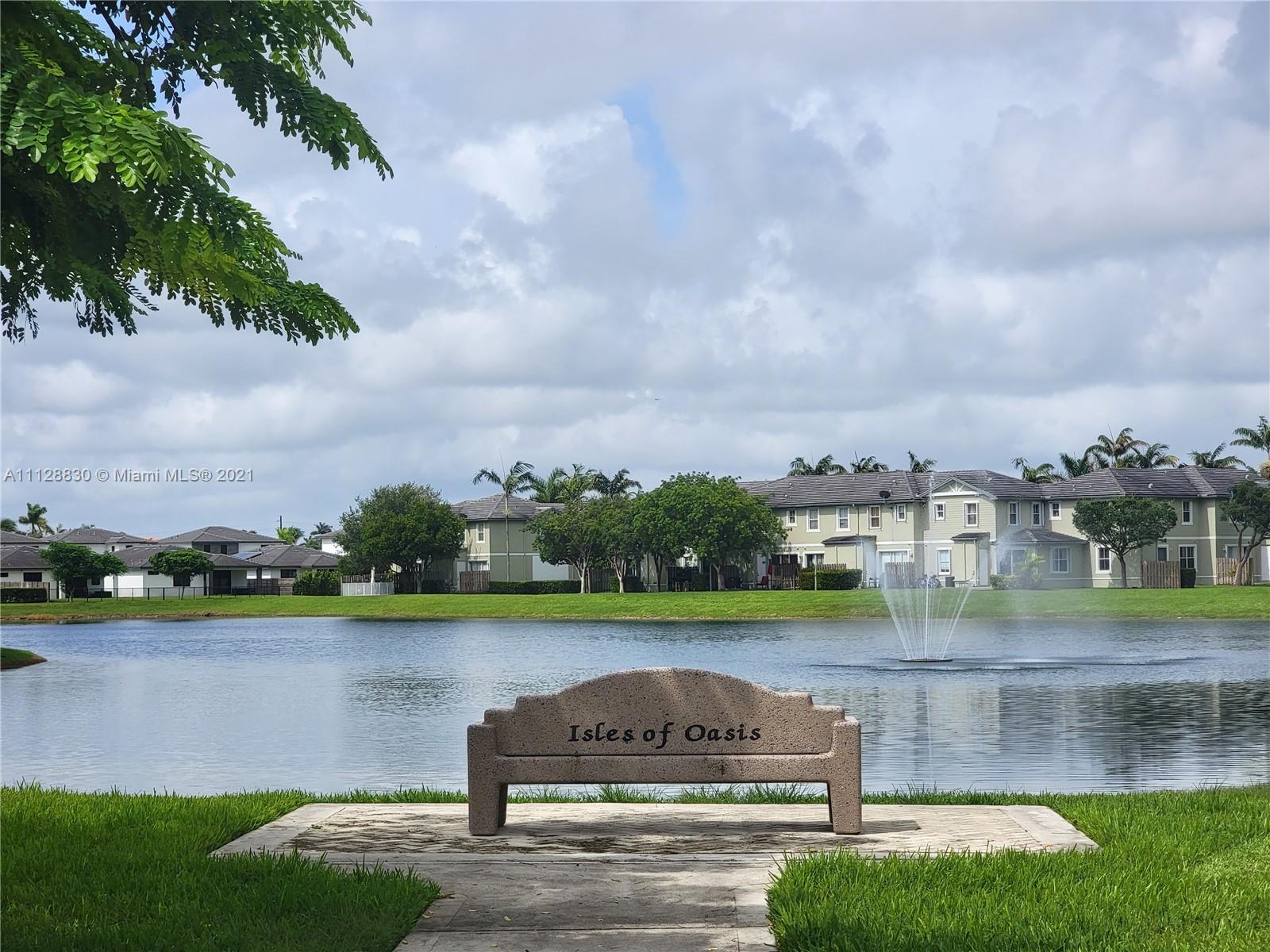 152 Southeast 29th Avenue, Unit 3 Homestead, FL 33033 - Photo 23 of 28 a view of a lake with houses in the back