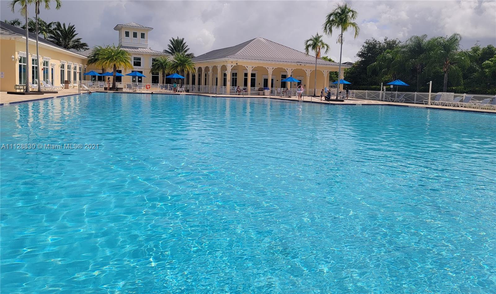 152 Southeast 29th Avenue, Unit 3 Homestead, FL 33033 - Photo 27 of 28 a view of a swimming pool with lawn chairs and potted plants