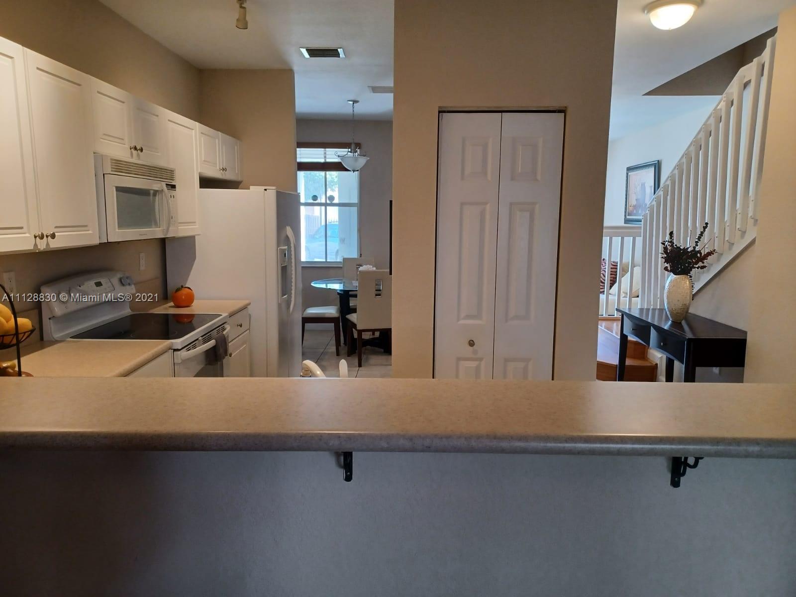 152 Southeast 29th Avenue, Unit 3 Homestead, FL 33033 - Photo 4 of 28 a kitchen with stainless steel appliances a sink and a refrigerator