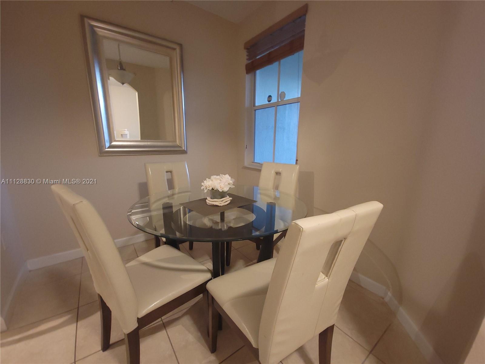 152 Southeast 29th Avenue, Unit 3 Homestead, FL 33033 - Photo 5 of 28 a view of a dining room with furniture and wooden floor