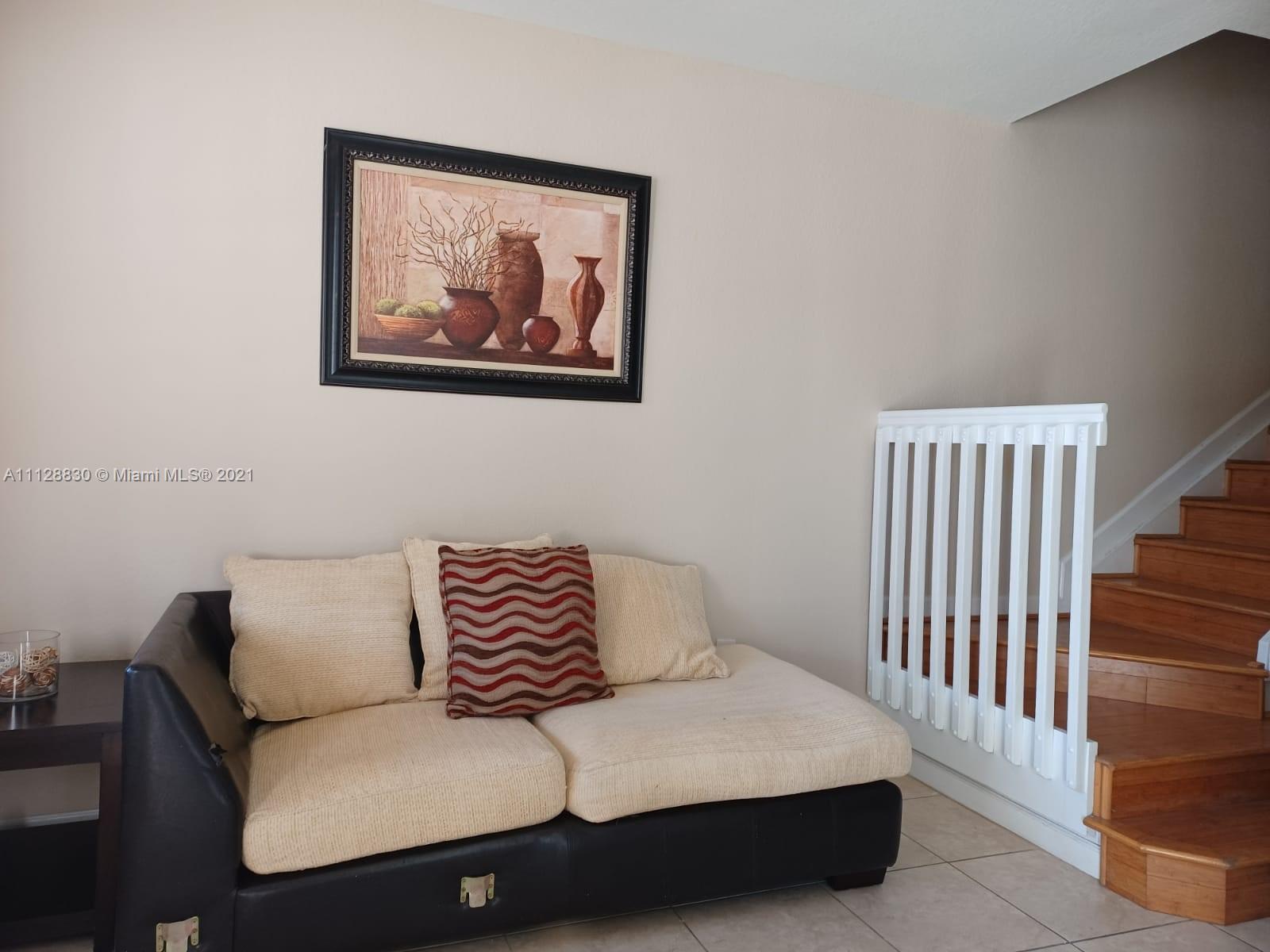 152 Southeast 29th Avenue, Unit 3 Homestead, FL 33033 - Photo 6 of 28 a bedroom with a bed and a painting on the wall