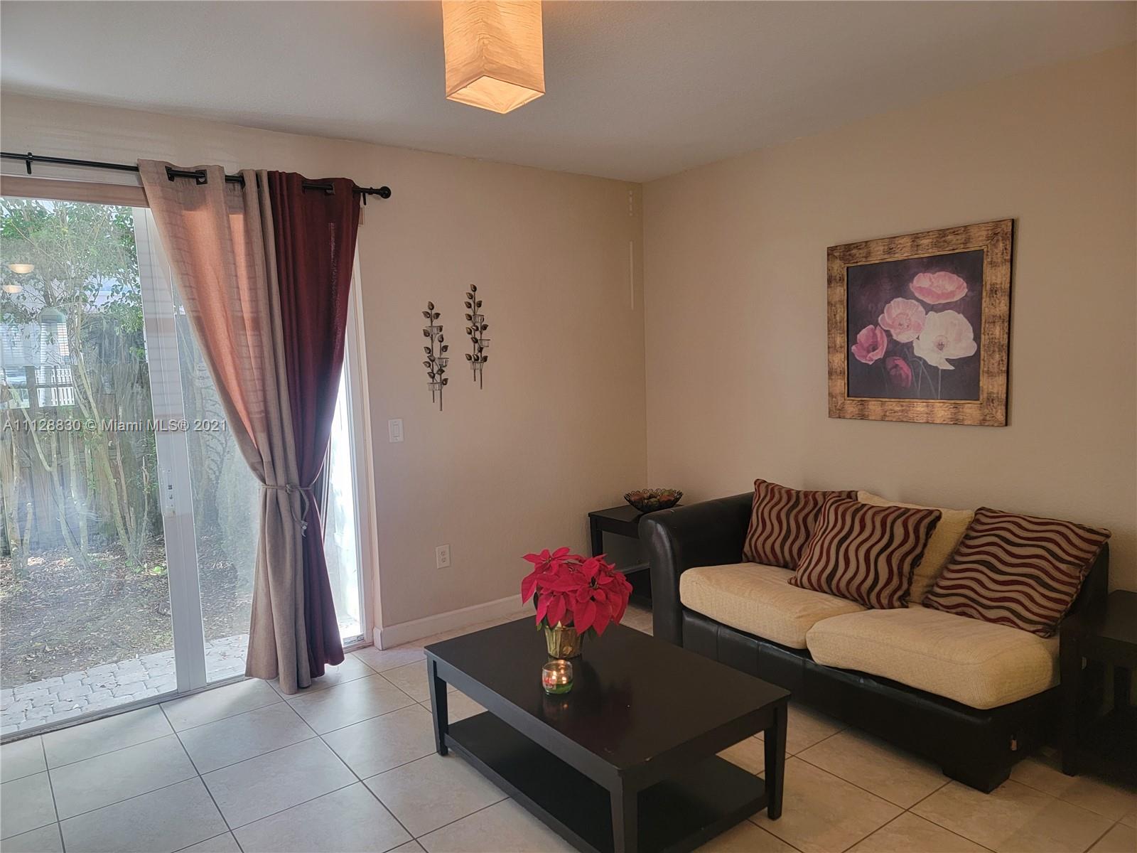 152 Southeast 29th Avenue, Unit 3 Homestead, FL 33033 - Photo 7 of 28 a living room with furniture and a large window
