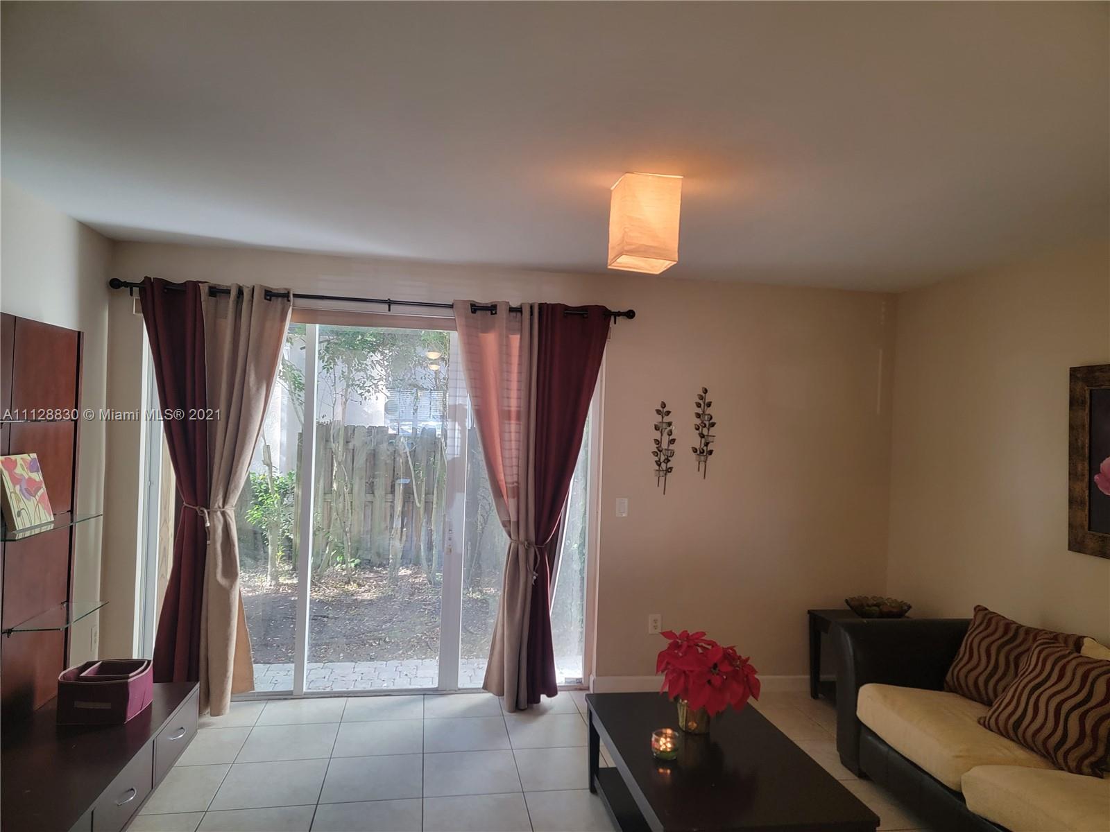 152 Southeast 29th Avenue, Unit 3 Homestead, FL 33033 - Photo 8 of 28 a living room with furniture and a large window