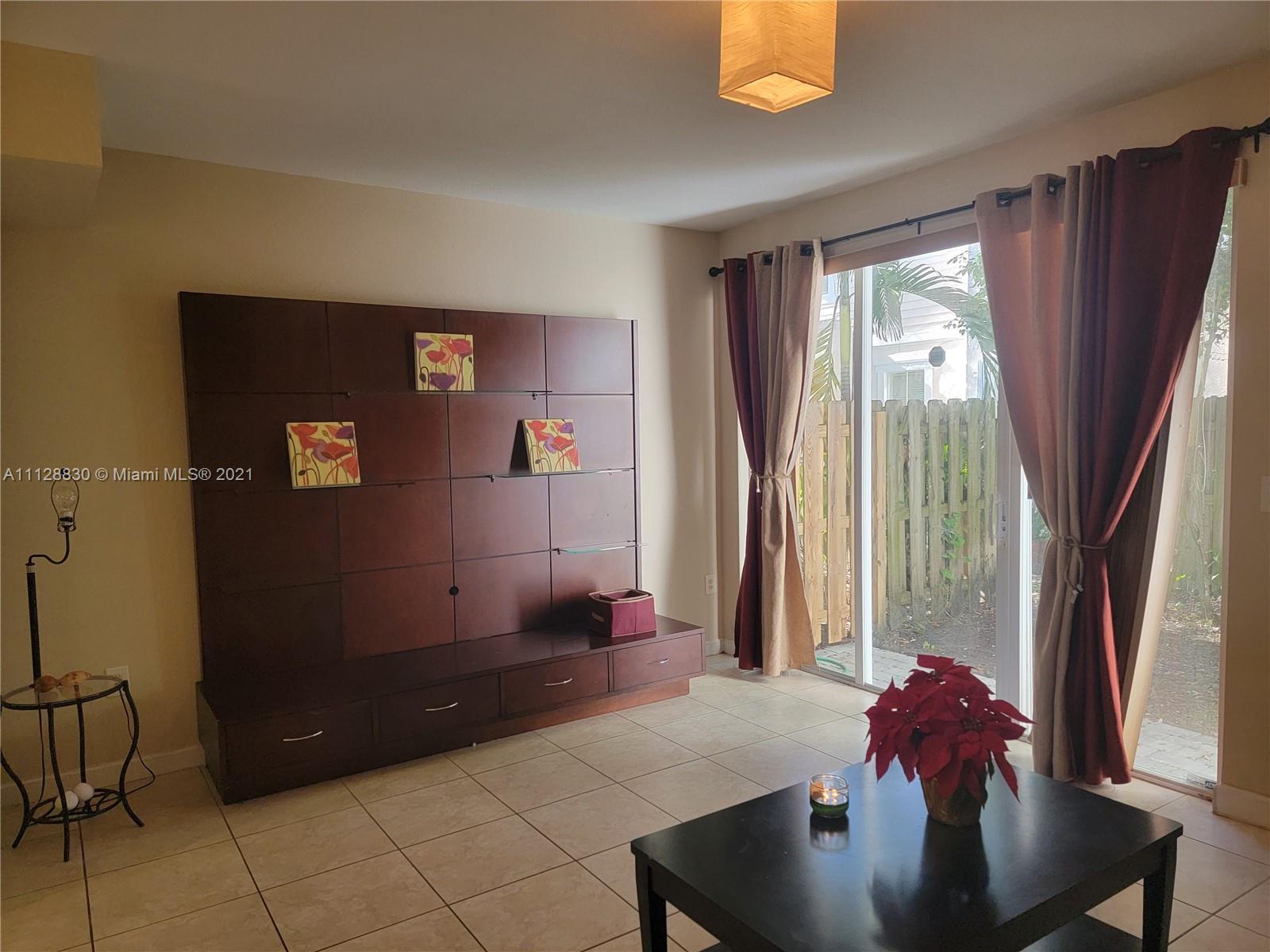 152 Southeast 29th Avenue, Unit 3 Homestead, FL 33033 - Photo 9 of 28 a living room with furniture and a potted plant