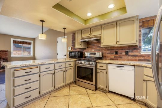 613 South Silver Ridge Street Ridgecrest, CA 93555 - Photo 9 of 26 a kitchen with stainless steel appliances granite countertop a sink and cabinets