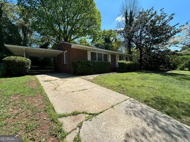 a front view of house with yard and trees