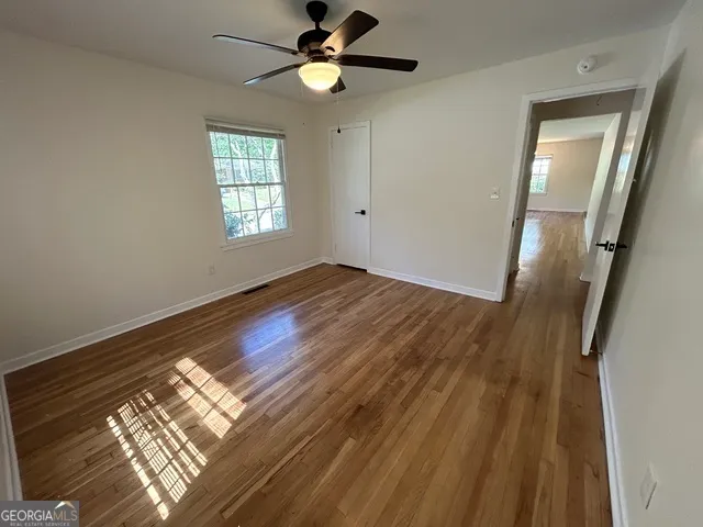 wooden floor in an empty room with a window