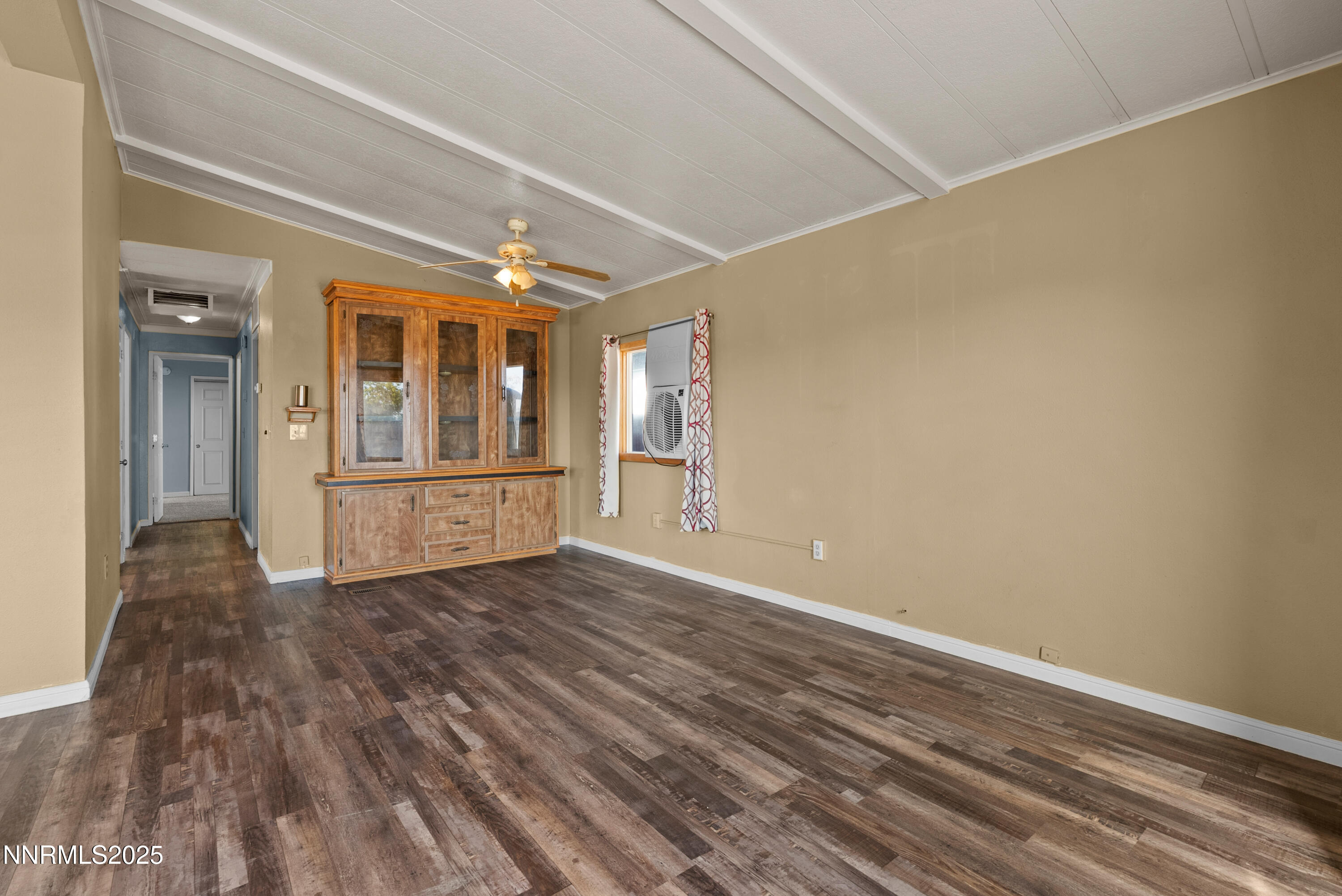 325 Parkland Way Fernley, NV 89408 - Photo 11 of 35 a view of an empty room with a window and wooden floor