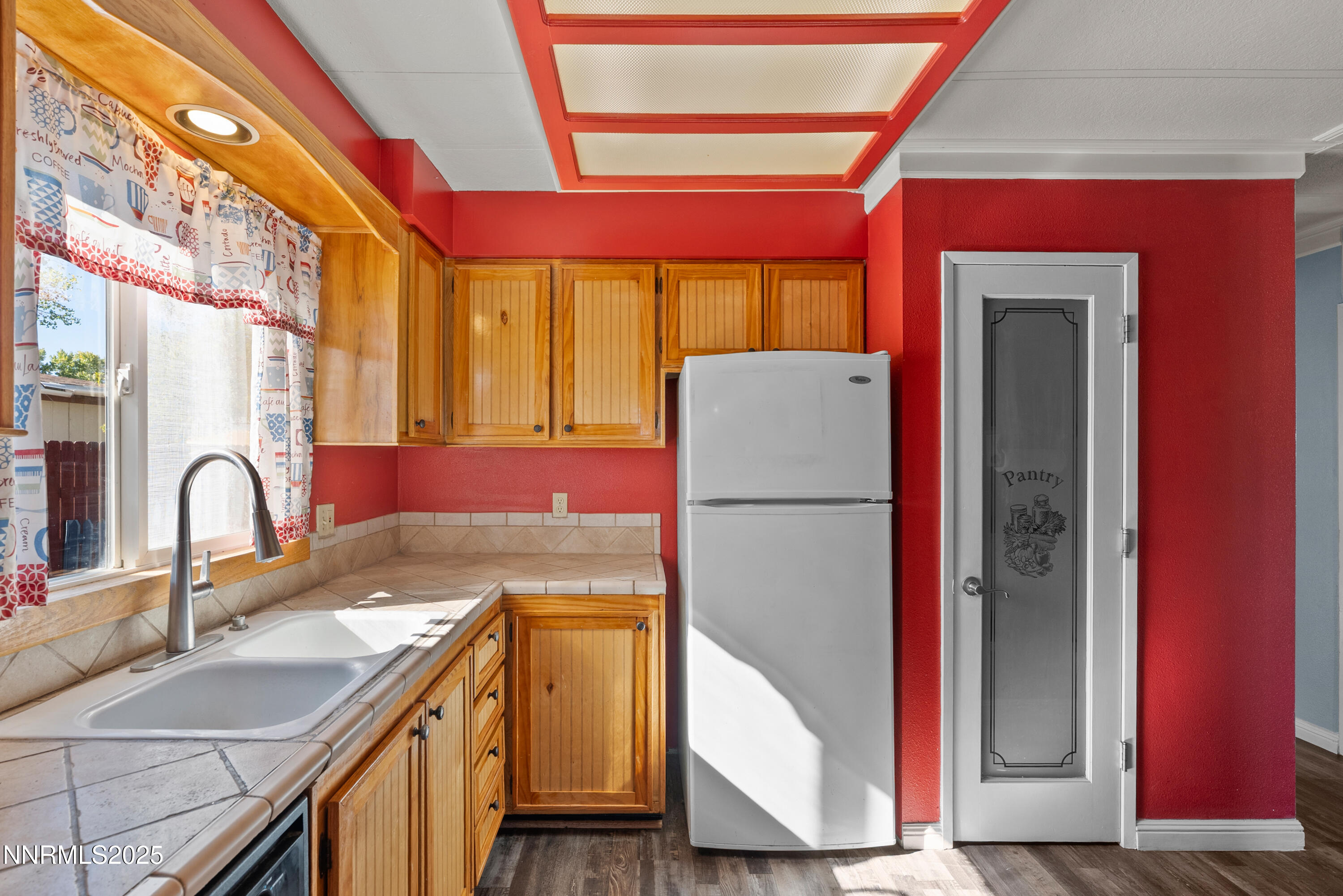 325 Parkland Way Fernley, NV 89408 - Photo 12 of 35 a kitchen with a sink a refrigerator and a stove