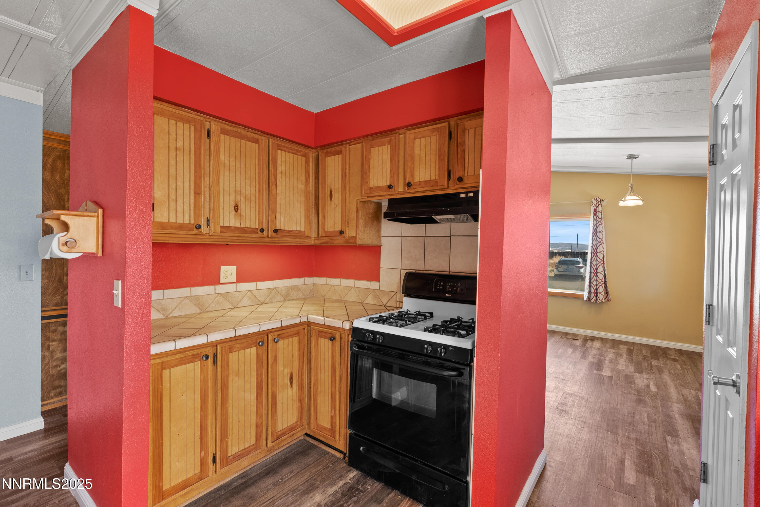 325 Parkland Way Fernley, NV 89408 - Photo 14 of 35 a kitchen with stainless steel appliances granite countertop a stove a sink and a microwave
