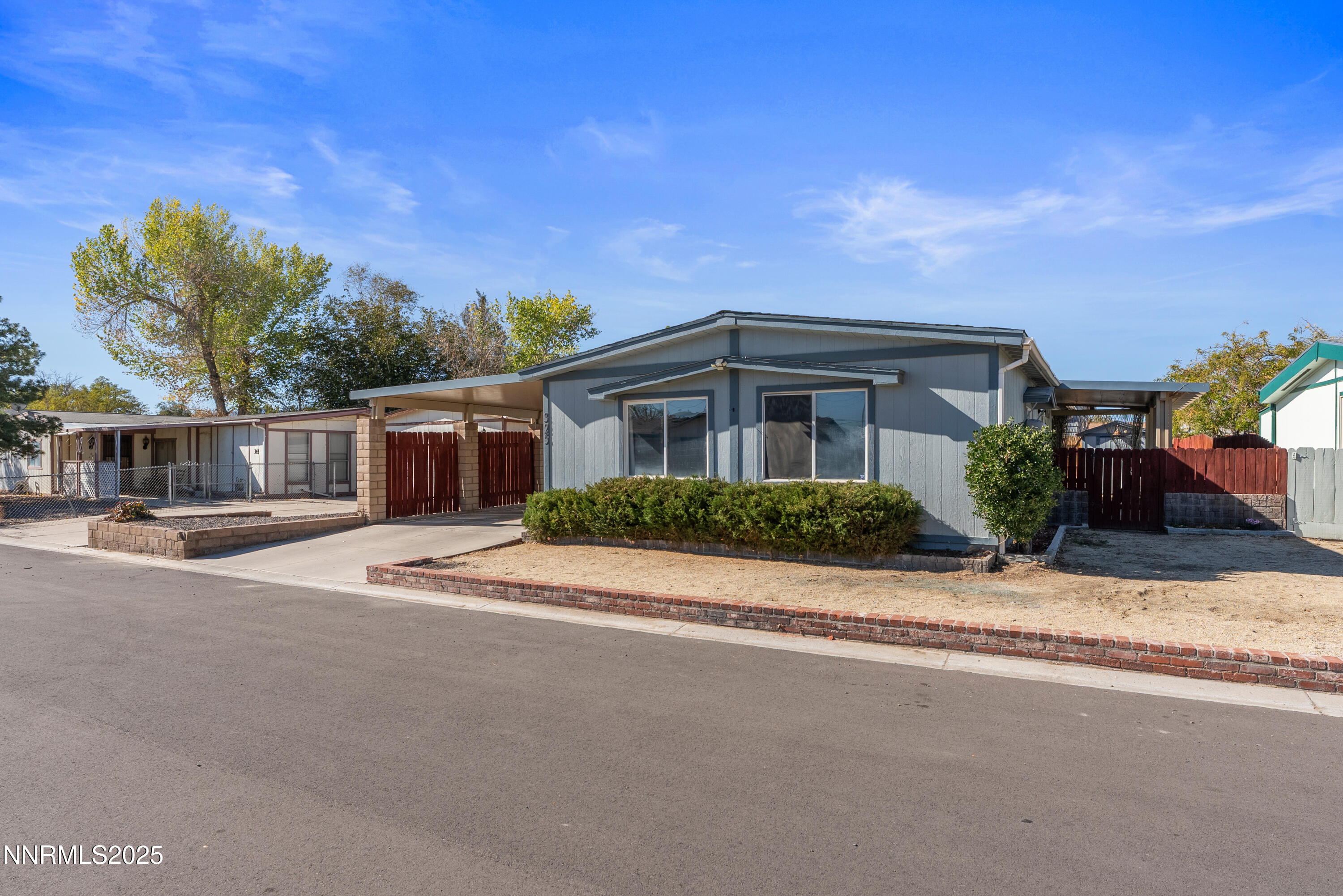 325 Parkland Way Fernley, NV 89408 - Photo 2 of 35 a front view of a house with a garden and pathway