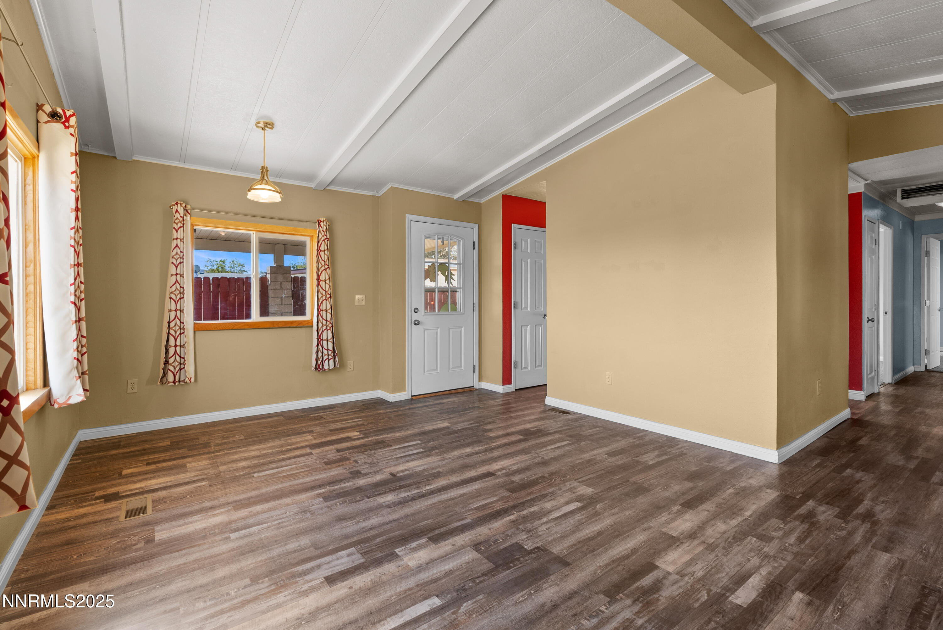 325 Parkland Way Fernley, NV 89408 - Photo 7 of 35 a view of an empty room with window and wooden floor