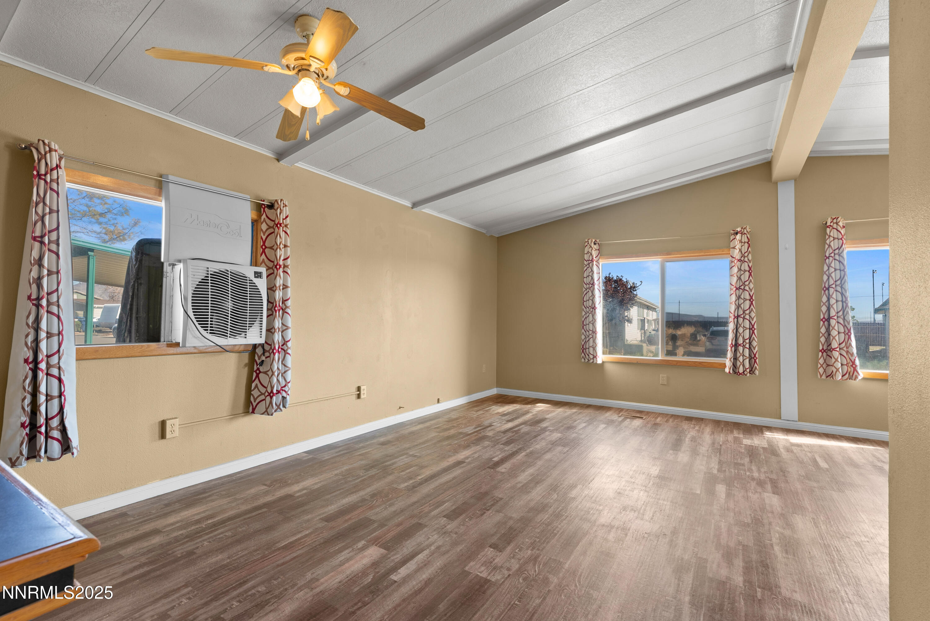 325 Parkland Way Fernley, NV 89408 - Photo 8 of 35 a view of a room with wooden floor and a ceiling fan