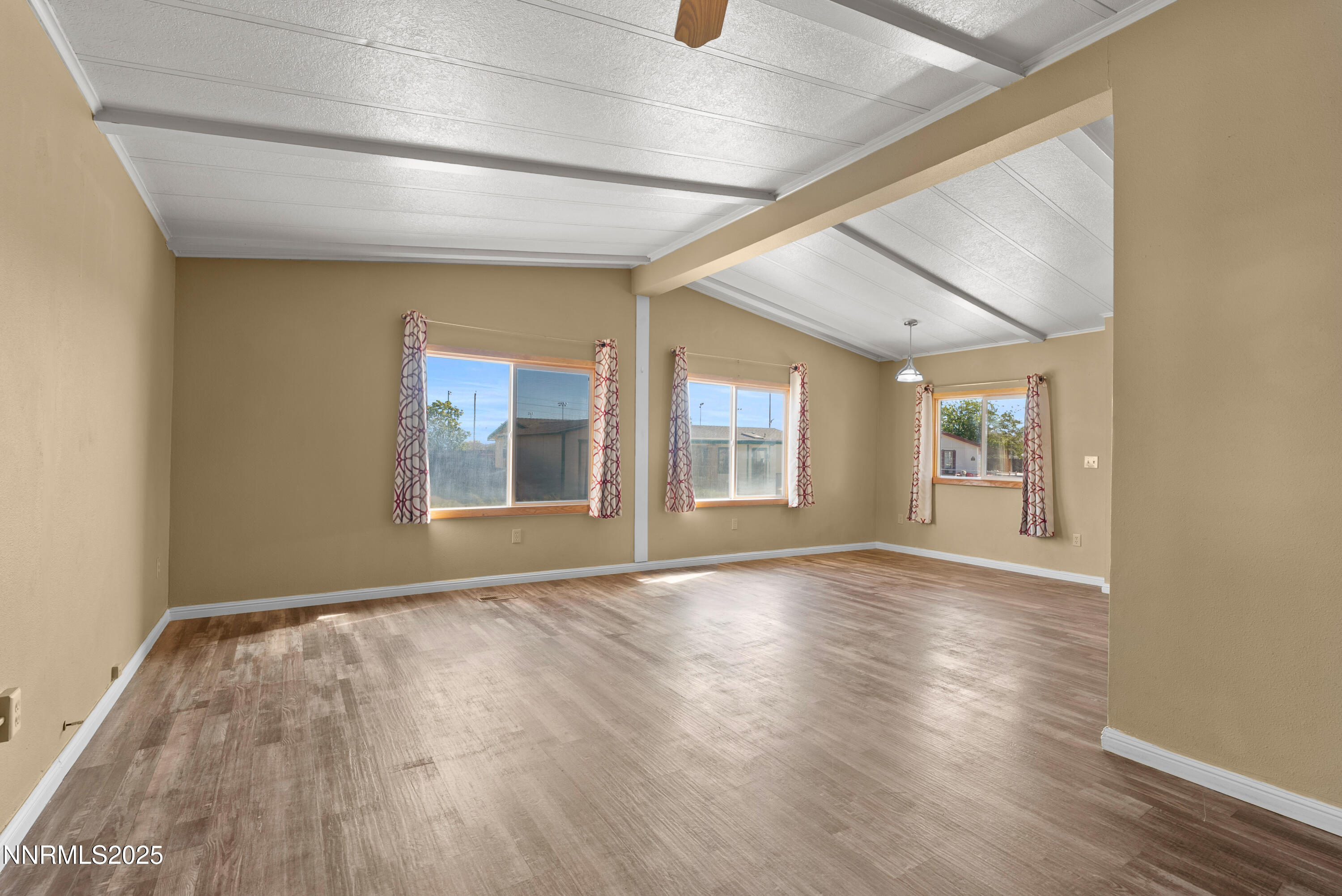 325 Parkland Way Fernley, NV 89408 - Photo 10 of 35 a view of an empty room with wooden floor and a window