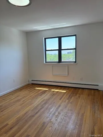 a view of a room with wooden floor and fan