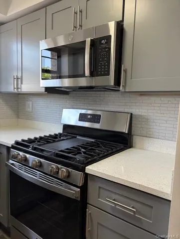 a stove top oven sitting inside of a kitchen and granite counter tops