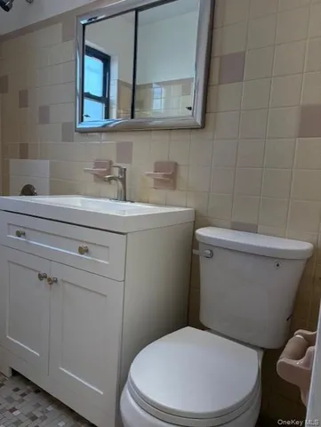 a white toilet sitting next to a bathroom sink