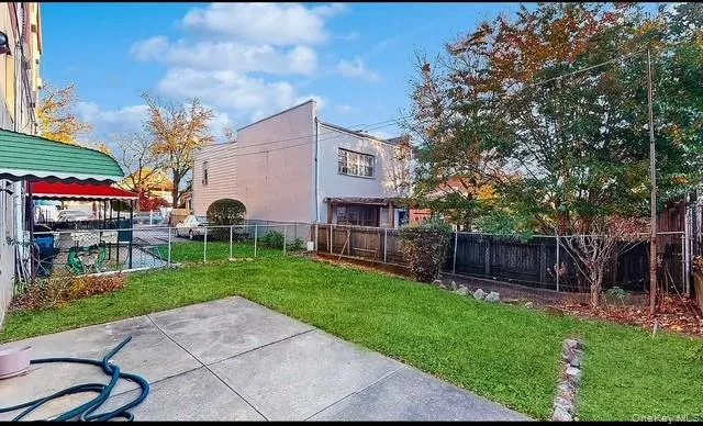 a view of a house with a yard and a table and chairs