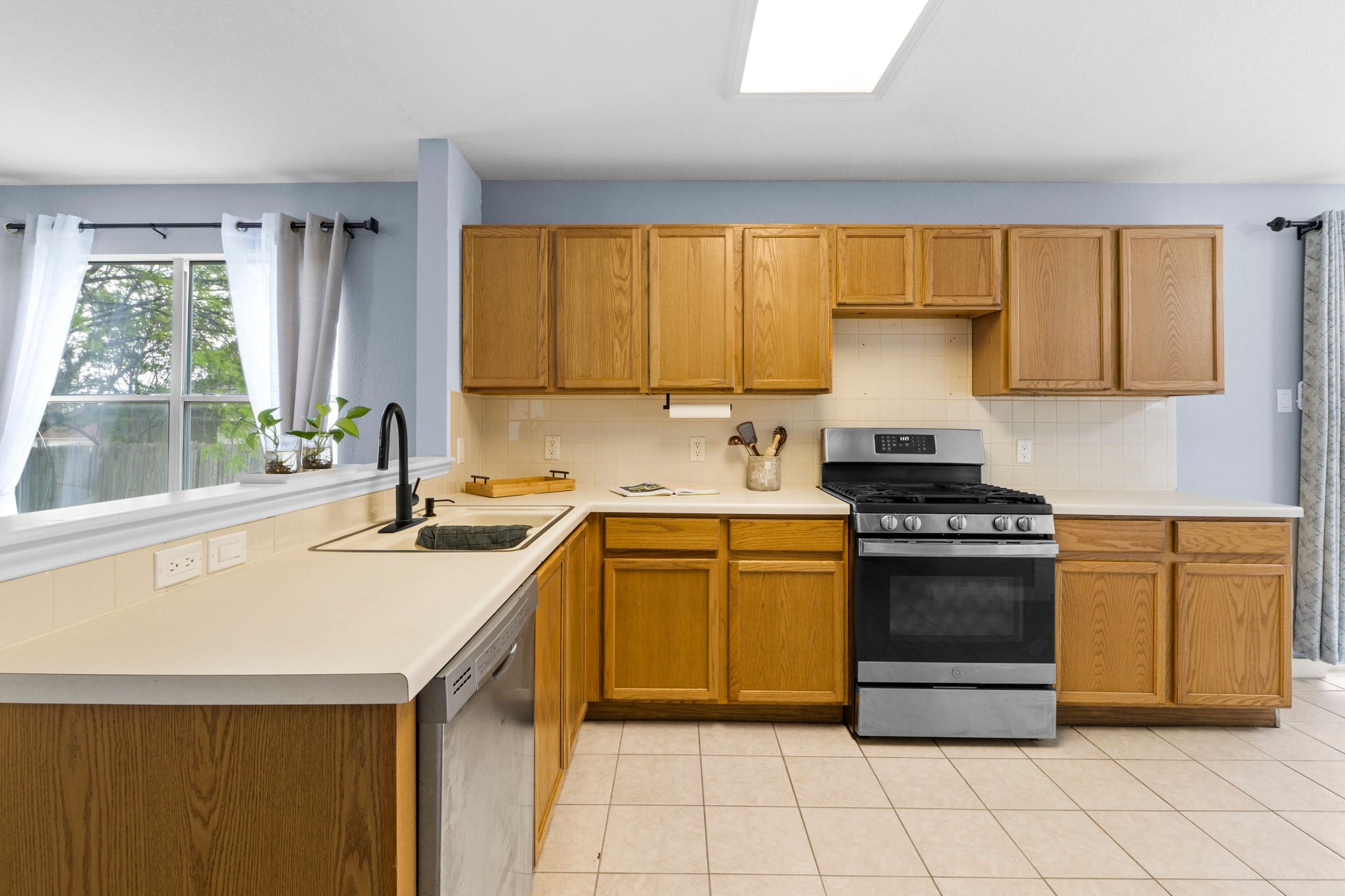 3811 Laurel Ridge Drive Round Rock, TX 78665 - Photo 15 of 35 a kitchen with a sink stove and cabinets