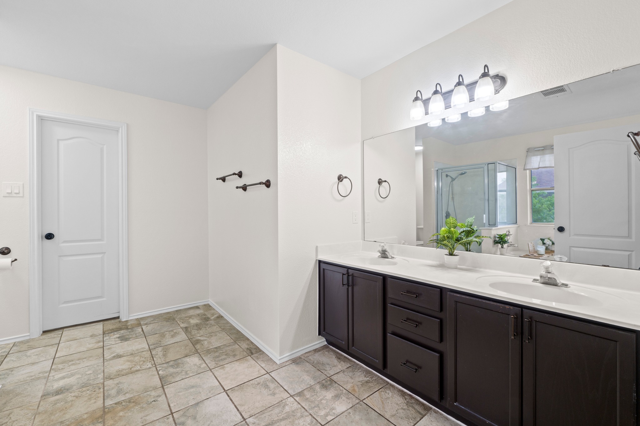 3811 Laurel Ridge Drive Round Rock, TX 78665 - Photo 23 of 35 a spacious bathroom with a double vanity sink a mirror and a shower