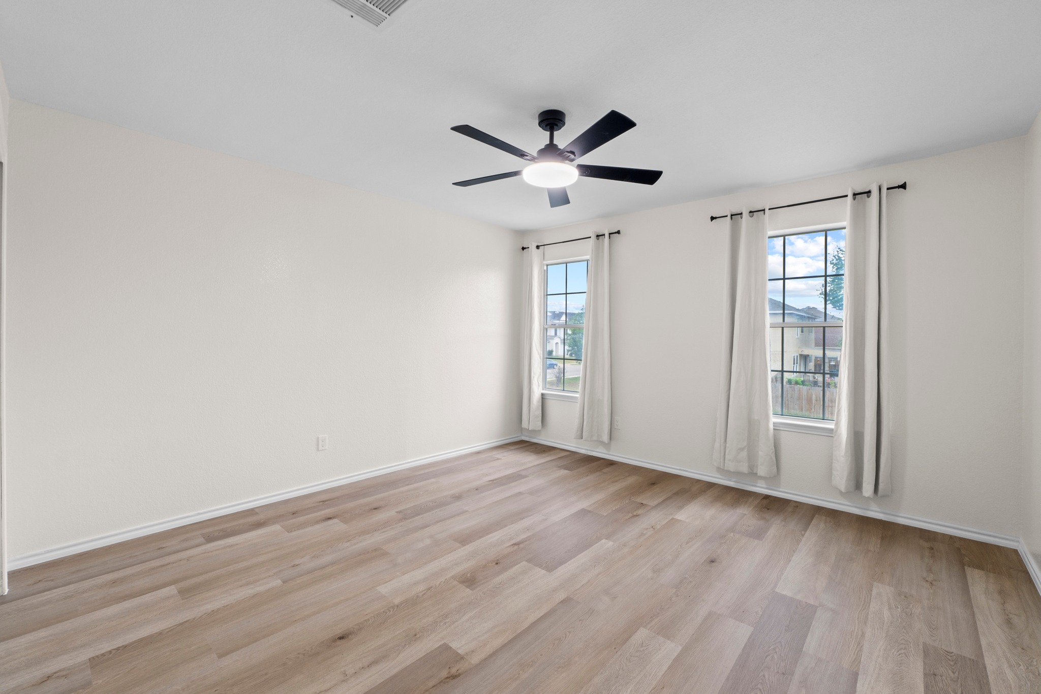 3811 Laurel Ridge Drive Round Rock, TX 78665 - Photo 27 of 35 a view of an empty room with wooden floor and a window