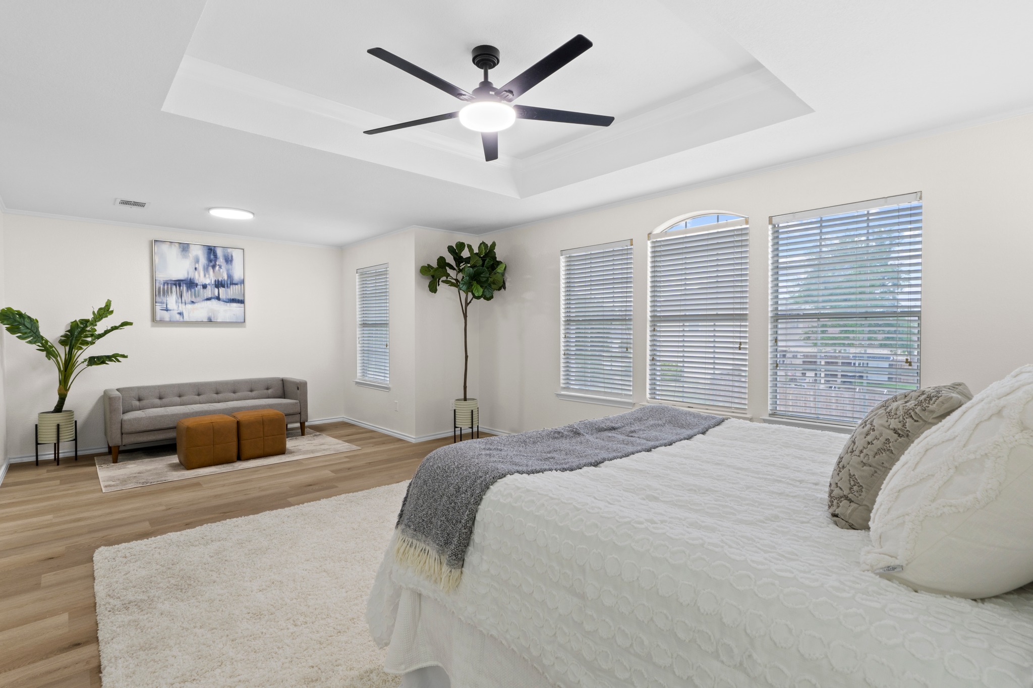 3811 Laurel Ridge Drive Round Rock, TX 78665 - Photo 4 of 35 a bedroom with a large bed a potted plant and a large window