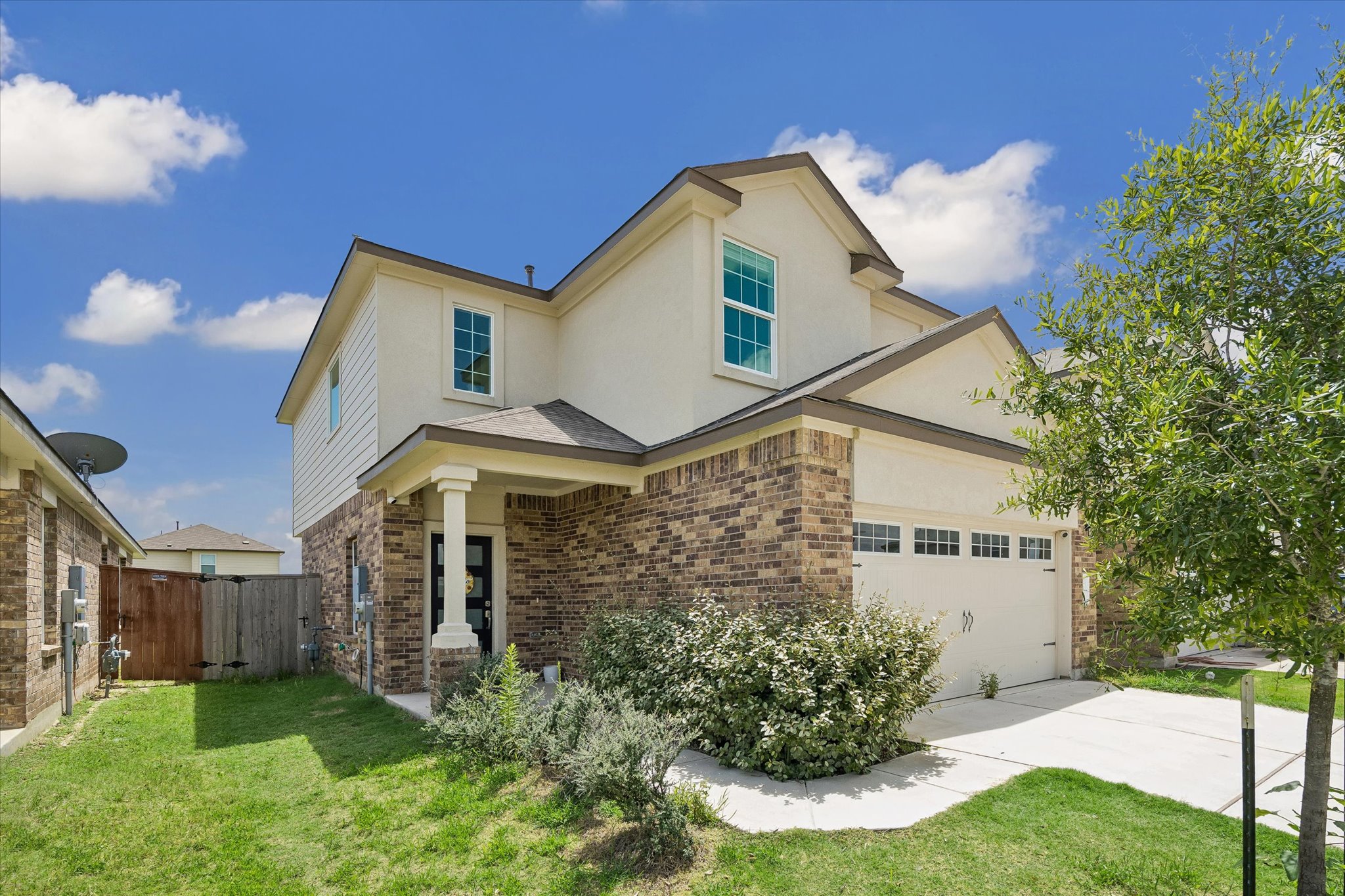 217 Canley Loop Hutto, TX 78634 - Photo 2 of 36 A welcoming brick and stucco facade offers excellent curb appeal and a convenient attached garage.